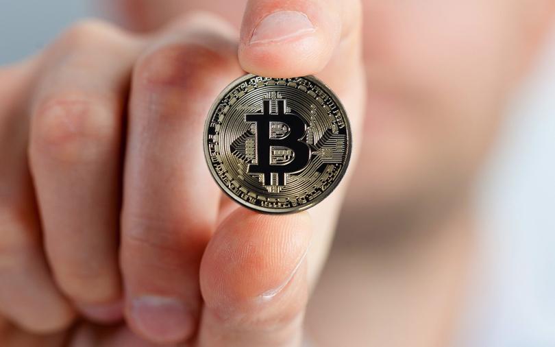 Bitcoin hits record high as developers, investors scrap plans to split currency