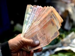 Rupee hits record low of 71 per dollar on global trade tensions