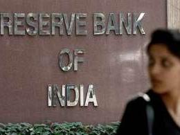 RBI keeps rates on hold, trims growth outlook
