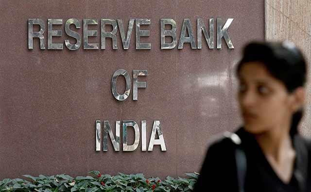 RBI keeps rates on hold, trims growth outlook